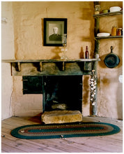 Load image into Gallery viewer, Photograph by Richard Heeps. Film set of 'The Outlaw Josey Wales' featuring a wooden fireplace and a black and white photo over the mantlepiece.