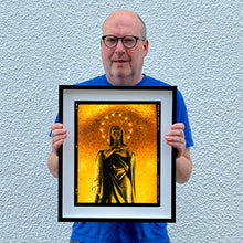 Load image into Gallery viewer, Richard Heeps holding Italian religious iconography photograph framed in black.