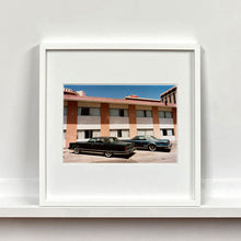 Load image into Gallery viewer, White framed photograph by Richard Heeps. This retro photograph has two classic Lincoln cars parked outside a hotel in Las Vegas. 