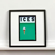 Load image into Gallery viewer, Black framed photograph by Richard Heeps.  At the top black letters spell out ICES and below is depicted a 99 icecream cone sitting left of centre against a viridian green coloured background.  
