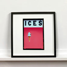 Load image into Gallery viewer, Black framed photograph by Richard Heeps.  At the top black letters spell out ICES and below is depicted a 99 icecream cone sitting left of centre against a coral coloured background.  