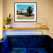 Load image into Gallery viewer, In situ photograph by Richard Heeps. A derelict motel office sits on a dusty American road. A large palm tree sits at the front of the office's walkway.