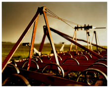 Load image into Gallery viewer, Photograph by Richard Heeps.  A plough sits in the middle of a fen field in the sunrise.