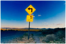 Load image into Gallery viewer, Part of Richard Heeps' 'Dream in Colour' Series, this beautiful picture taken at dusk captures the sunset in the valley.  It was photographed in what was once a goldmine, now a ghost town. The 5MPH sign seems so cautious, but on closer inspection you see that it is peppered with bullet holes, serving as a reminder of its Western past. 
