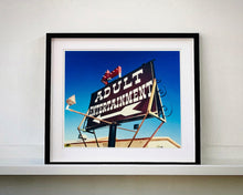 Load image into Gallery viewer, 'Adult Entertainment' photographed in Beatty, Nevada, shows bold typography sitting prominently on an American road sign, against a background of bright blue sky. This fun and cheeky artwork was captured on a road trip through America and features in Richard Heeps' sold out book 'Man's Ruin'. An edition of this artwork recently sold at auction in The Auction Collective exhibition 'Hypercolor-Pop-Culture'.