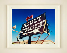 Load image into Gallery viewer, 'Adult Entertainment' photographed in Beatty, Nevada, shows bold typography sitting prominently on an American road sign, against a background of bright blue sky. This fun and cheeky artwork was captured on a road trip through America and features in Richard Heeps' sold out book 'Man's Ruin'. An edition of this artwork recently sold at auction in The Auction Collective exhibition 'Hypercolor-Pop-Culture'.