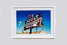 Load image into Gallery viewer, 'Adult Entertainment' photographed in Beatty, Nevada, shows bold typography sitting prominently on an American road sign, against a background of bright blue sky. This fun and cheeky artwork was captured on a road trip through America and features in Richard Heeps' sold out book 'Man's Ruin'. An edition of this artwork recently sold at auction in The Auction Collective exhibition 'Hypercolor-Pop-Culture'.