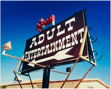 Load image into Gallery viewer, 'Adult Entertainment' photographed in Beatty, Nevada, shows bold typography sitting prominently on an American road sign, against a background of bright blue sky. This fun and cheeky artwork was captured on a road trip through America and features in Richard Heeps' sold out book 'Man's Ruin'. An edition of this artwork recently sold at auction in The Auction Collective exhibition 'Hypercolor-Pop-Culture'.