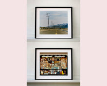 Load image into Gallery viewer, An open road in Amboy, California, featuring telephone poles disappearing into the mountainous distance. This classic and timeless landscape photograph is part of Richard Heeps' 'Dream in Colour' series. 
