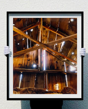Load image into Gallery viewer, Light breaks through the cracks in the barn on the movie set of Clint Eastwood's Western film 'The Outlaw Josey Wales'. Captured in Kanab, Utah, which was the setting of many Western movies. Photographed by Richard Heeps for his 'Dream in Colour' series.