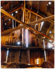 Load image into Gallery viewer, Light breaks through the cracks in the barn on the movie set of Clint Eastwood's Western film 'The Outlaw Josey Wales'. Captured in Kanab, Utah, which was the setting of many Western movies. Photographed by Richard Heeps for his 'Dream in Colour' series.