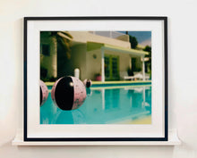 Load image into Gallery viewer, Part of Richard Heeps' 'Dream in Colour' Series, 'Beach Ball' captures Palm Springs mid-century modern architecture behind a trio of pink and black beach balls. The stillness and the subtle colours combine to make a calming artwork with a seductive cinematic vibe.