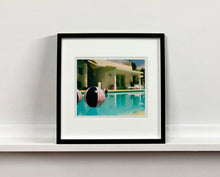 Load image into Gallery viewer, Part of Richard Heeps' 'Dream in Colour' Series, 'Beach Ball' captures Palm Springs mid-century modern architecture behind a trio of pink and black beach balls. The stillness and the subtle colours combine to make a calming artwork with a seductive cinematic vibe.
