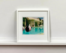 Load image into Gallery viewer, Part of Richard Heeps' 'Dream in Colour' Series, 'Beach Ball' captures Palm Springs mid-century modern architecture behind a trio of pink and black beach balls. The stillness and the subtle colours combine to make a calming artwork with a seductive cinematic vibe.