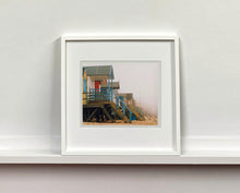 Load image into Gallery viewer, 'Beach Huts', photographed by Richard Heeps in one of his favourite areas of the UK, the port town of Wells-next-the-sea, Norfolk. This piece captures the classic quintessential beach hut on an atmospherically foggy day.