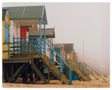 Load image into Gallery viewer, 'Beach Huts', photographed by Richard Heeps in one of his favourite areas of the UK, the port town of Wells-next-the-sea, Norfolk. This piece captures the classic quintessential beach hut on an atmospherically foggy day.