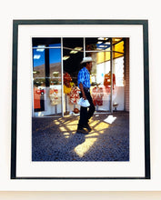Load image into Gallery viewer, 'Boutique' is street portrait, taken in Palm Springs, California. This piece is different from Richard Heeps' usual style, but everything fell into place: the light, the colours, and the man walking through the shot.