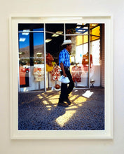 Load image into Gallery viewer, 'Boutique' is street portrait, taken in Palm Springs, California. This piece is different from Richard Heeps' usual style, but everything fell into place: the light, the colours, and the man walking through the shot.