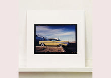 Load image into Gallery viewer, 'Chevy at the Diner' was photographed in Bisbee, Arizona in 2001 but printed by Richard in his darkroom for the first time more recently in 2018. This cinematic artwork that features a vintage yellow chevy parked up at a Diner will take you on an American road trip. 