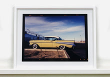 Load image into Gallery viewer, 'Chevy at the Diner' was photographed in Bisbee, Arizona in 2001 but printed by Richard in his darkroom for the first time more recently in 2018. This cinematic artwork that features a vintage yellow chevy parked up at a Diner will take you on an American road trip. 