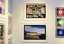 Load image into Gallery viewer, 'Chevy at the Diner' was photographed in Bisbee, Arizona in 2001 but printed by Richard in his darkroom for the first time more recently in 2018. This cinematic artwork that features a vintage yellow chevy parked up at a Diner will take you on an American road trip. 