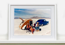 Load image into Gallery viewer, 'Christine's '52 Henry J &amp; teardrop' was captured in Bonneville Salt Flats, Utah, the iconic home of speed. This photograph shows the mountains in the distance meeting and contrasting with the flatness of the salt pan, whilst a pair of retro spectators look out at the speeding cars in the distance.