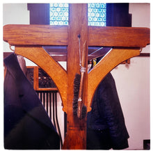 Load image into Gallery viewer, Photograph by Richard Heeps. A wooden coat stand with a coat brush hanging from a piece of string. 