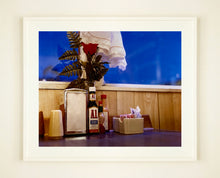 Load image into Gallery viewer, 'Condiments' shows a classic American Diner table-scape, captured at the Bonanza Café in the small town of Lone Pine, California. This piece is part of Richard Heeps' 'Dream in Colour' series.