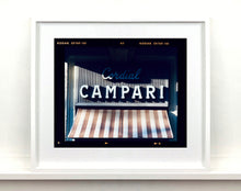Load image into Gallery viewer, Cordial Campari, photographed as part of Richard Heeps’ series 'A Short History of Milan’ features beautiful and bold typography above the striped awning of a fascist building. 
