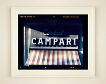 Load image into Gallery viewer, Cordial Campari, photographed as part of Richard Heeps’ series 'A Short History of Milan’ features beautiful and bold typography above the striped awning of a fascist building. 