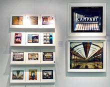 Load image into Gallery viewer, Cordial Campari, photographed as part of Richard Heeps’ series 'A Short History of Milan’ features beautiful and bold typography above the striped awning of a fascist building. 