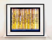 Load image into Gallery viewer, As part of Richard Heeps' series, A Short History of Milan, Delitto A Hollywood features a series of yellow Italian books from a street kiosk. 