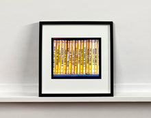 Load image into Gallery viewer, As part of Richard Heeps' series, A Short History of Milan, Delitto A Hollywood features a series of yellow Italian books from a street kiosk. 