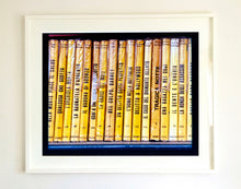 Load image into Gallery viewer, As part of Richard Heeps' series, A Short History of Milan, Delitto A Hollywood features a series of yellow Italian books from a street kiosk. 