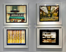 Load image into Gallery viewer, As part of Richard Heeps' series, A Short History of Milan, Delitto A Hollywood features a series of yellow Italian books from a street kiosk. 