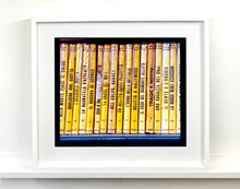 Load image into Gallery viewer, As part of Richard Heeps' series, A Short History of Milan, Delitto A Hollywood features a series of yellow Italian books from a street kiosk. 