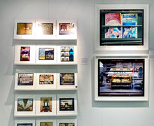 Load image into Gallery viewer, As part of Richard Heeps' series, A Short History of Milan, Desire features Italian books from a street kiosk. 