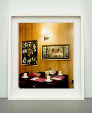 Load image into Gallery viewer, This photograph was taken inside the dining room of the iconic Parry Lodge in Kanab, Utah, which once hosted movie stars of the Western films made in the area. Their faces, cutouts from Life Magazine, adorned the wood panelled walls, which combined with the vintage interior, creates a mid-century cinematic atmosphere. This piece is part of Richard Heeps' 'Dream in Colour' series.