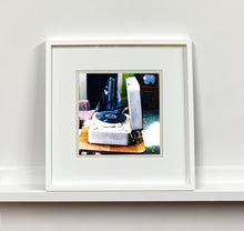 Load image into Gallery viewer, Disc Jockey, photographed by Richard Heeps at Preston Hall Museum, he was commissioned to photograph the museum before it went through regeneration. There is an air of nostalgia in the room of this interior photograph, featuring a retro table-top record player with a Decca vinyl record.