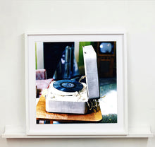 Load image into Gallery viewer, Disc Jockey, photographed by Richard Heeps at Preston Hall Museum, he was commissioned to photograph the museum before it went through regeneration. There is an air of nostalgia in the room of this interior photograph, featuring a retro table-top record player with a Decca vinyl record.