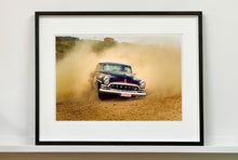 Load image into Gallery viewer, 'Donut' shows a classic American car donut driving on a Norfolk beach in the East of England. This photograph was captured at Hemsby Rock and Roll weekend, and is part of Richard Heeps' Man's Ruin' series.