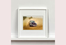 Load image into Gallery viewer, 'Donut' shows a classic American car donut driving on a Norfolk beach in the East of England. This photograph was captured at Hemsby Rock and Roll weekend, and is part of Richard Heeps' Man's Ruin' series.