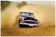Load image into Gallery viewer, 'Donut' shows a classic American car donut driving on a Norfolk beach in the East of England. This photograph was captured at Hemsby Rock and Roll weekend, and is part of Richard Heeps' Man's Ruin' series.