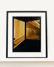 Load image into Gallery viewer, 'Door - Lariat Motel' is a cinematic scene showing a doorway in the glowing evening light, with the setting sun casting shadows across the architecture. Richard Heeps photographed this artwork in Fallon, Nevada whilst on an American road trip. This artwork is part of Richard's 'Dream in Colour' series. 