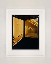 Load image into Gallery viewer, 'Door - Lariat Motel' is a cinematic scene showing a doorway in the glowing evening light, with the setting sun casting shadows across the architecture. Richard Heeps photographed this artwork in Fallon, Nevada whilst on an American road trip. This artwork is part of Richard's 'Dream in Colour' series. 