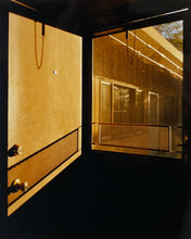 Load image into Gallery viewer, 'Door - Lariat Motel' is a cinematic scene showing a doorway in the glowing evening light, with the setting sun casting shadows across the architecture. Richard Heeps photographed this artwork in Fallon, Nevada whilst on an American road trip. This artwork is part of Richard's 'Dream in Colour' series. 