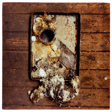 Load image into Gallery viewer, Photograph by Richard Heeps. A broken drip tray sits in the middle of a wooden slated table. 