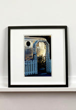 Load image into Gallery viewer, Part of Richard Heeps' 'Dream in Colour' series, this photograph features a white picket fence entrance to the Royal Mansion at the Shady Dell Trailer Park in Bisbee. Arizona. 
