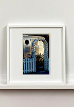 Load image into Gallery viewer, Part of Richard Heeps' 'Dream in Colour' series, this photograph features a white picket fence entrance to the Royal Mansion at the Shady Dell Trailer Park in Bisbee. Arizona. 