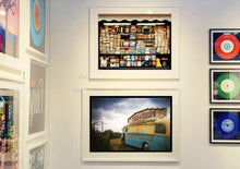Load image into Gallery viewer, A moody Fenland sky is backdrop to a classic British Fish &amp; Chips Van. The typography and the van itself has a fun fairground feel, contrary to the muted tones of this piece. Part of Richard Heeps series, 'A View of the Fens from the Car with Wings'.